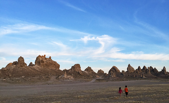 Kids walking across the large lot next to the Trona Pinnacles where a couple RVs were parked for the nght